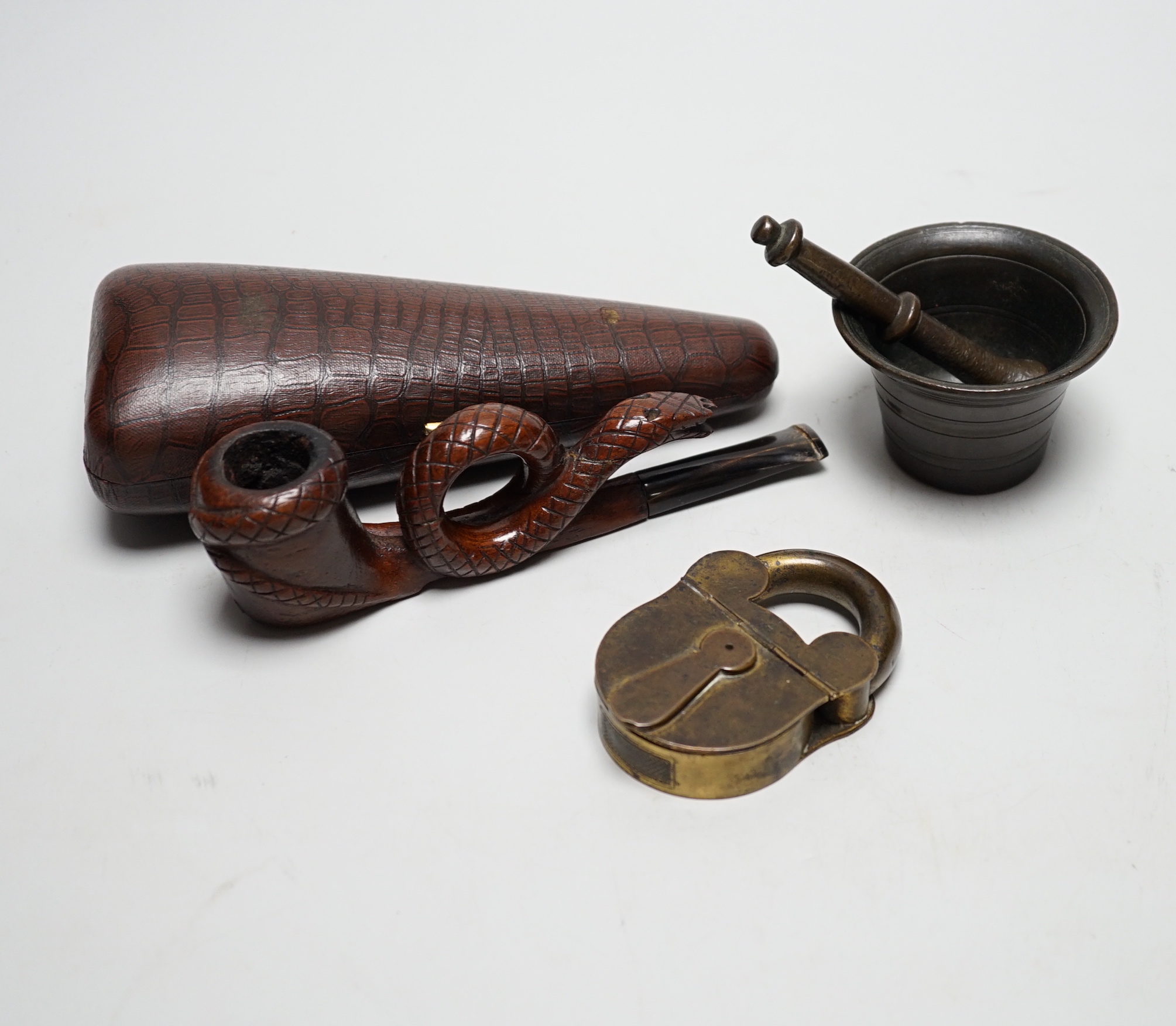 A novelty cased pipe, a miniature pestle and mortar and a novelty vesta case